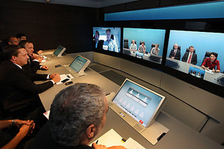 Dr. Hannes Ametsreiter, CEO of mobilkom austria and Telekom Austria, CTO DI Walter Goldenits and journalists at the LTE demonstration in one of the TelePresence rooms by Telekom Austria.